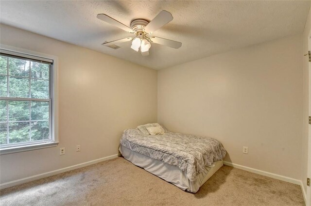 5385 Spotted Fawn Ct, Suwanee, GA 30024 - bedroom with carpet, a textured ceiling, and ceiling fan