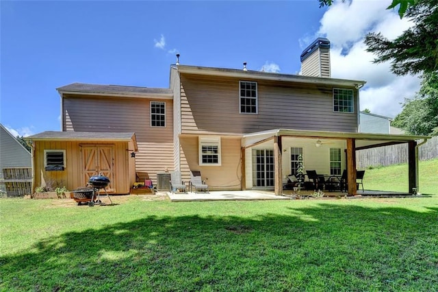 5385 Spotted Fawn Ct, Suwanee, GA 30024 - back of property featuring a chimney, a patio area, and a lawn