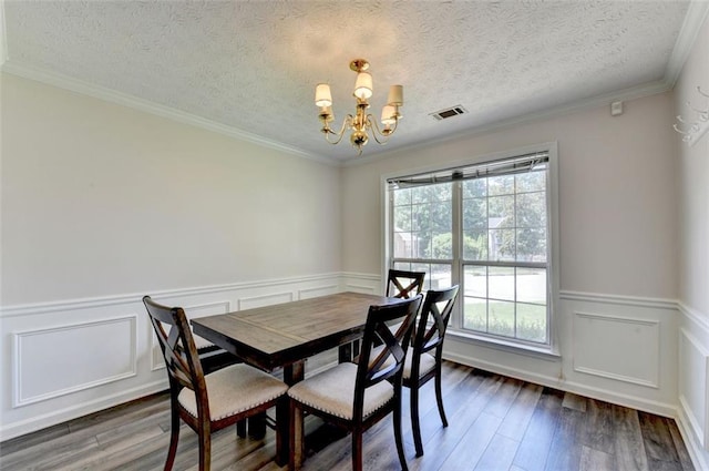 5385 Spotted Fawn Ct, Suwanee, GA 30024 - dining area with a chandelier, wood finished floors, a wainscoted wall, a textured ceiling, and ornamental molding