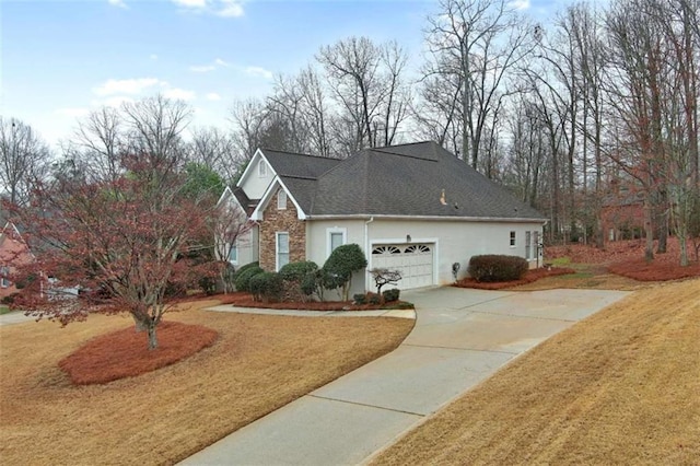 view of front of house featuring stucco siding, driveway, a front lawn, and a garage