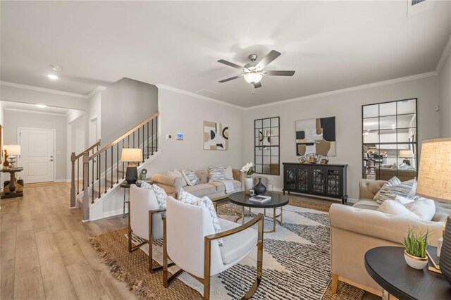 living room featuring ornamental molding, ceiling fan, and light hardwood / wood-style floors