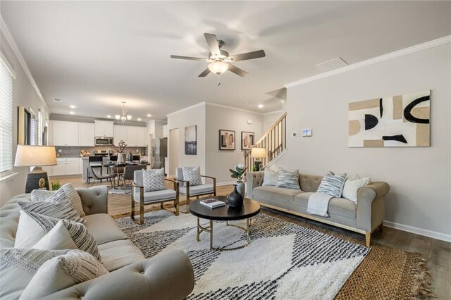 living room featuring ornamental molding, ceiling fan, and light hardwood / wood-style floors