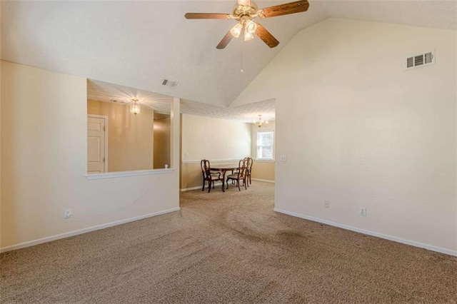 unfurnished room with visible vents, carpet floors, high vaulted ceiling, and baseboards