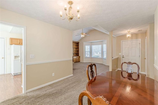 dining room featuring light carpet, baseboards, a textured ceiling, and lofted ceiling