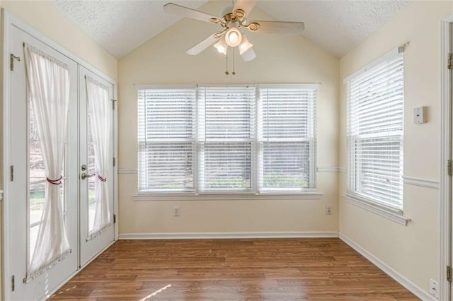 interior space featuring lofted ceiling and a ceiling fan