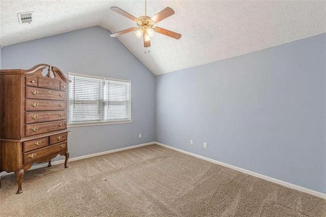 unfurnished bedroom with baseboards, carpet floors, a textured ceiling, and lofted ceiling