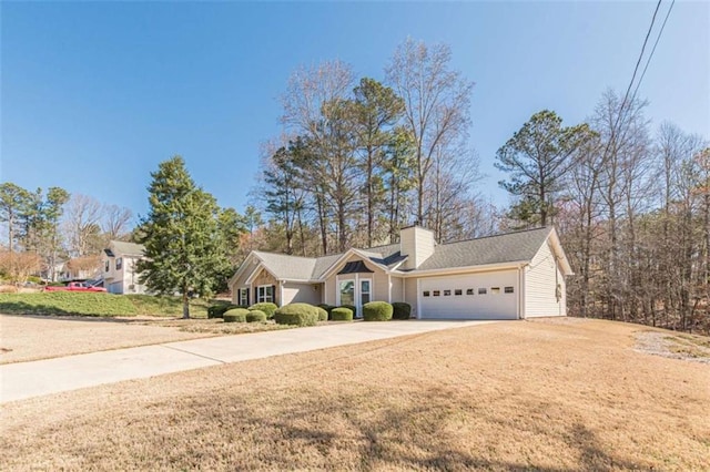 ranch-style home with a chimney, an attached garage, concrete driveway, and a front yard