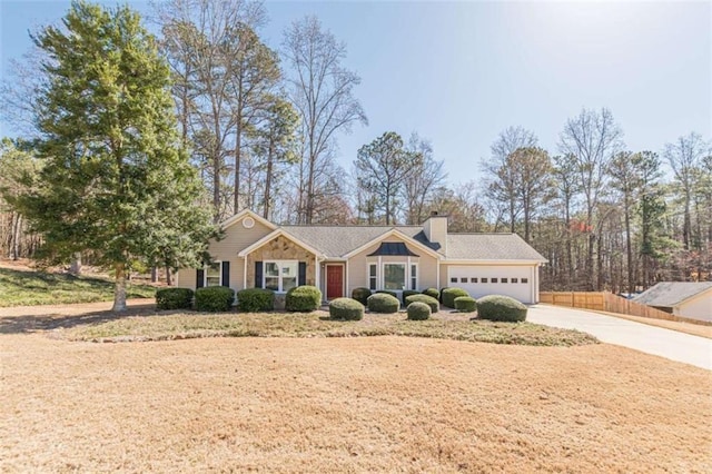 ranch-style house with an attached garage, a chimney, driveway, and fence