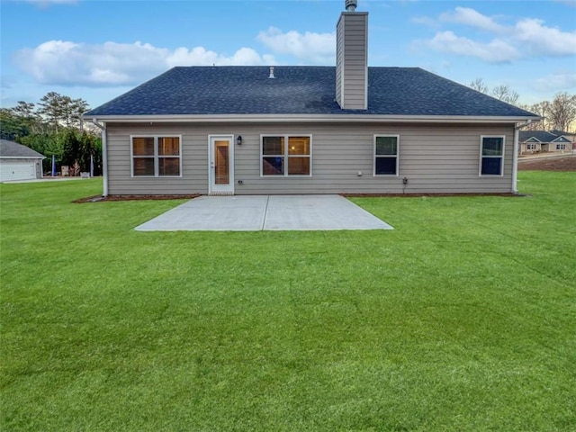 back of property featuring a patio area, a yard, a chimney, and roof with shingles