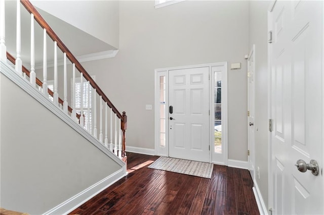 entryway with a towering ceiling and wood-type flooring