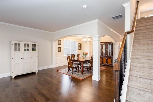 637 Little Bear Loop, Canton, GA 30114 - dining room featuring arched walkways, ornate columns, dark wood finished floors, stairs, and ornamental molding