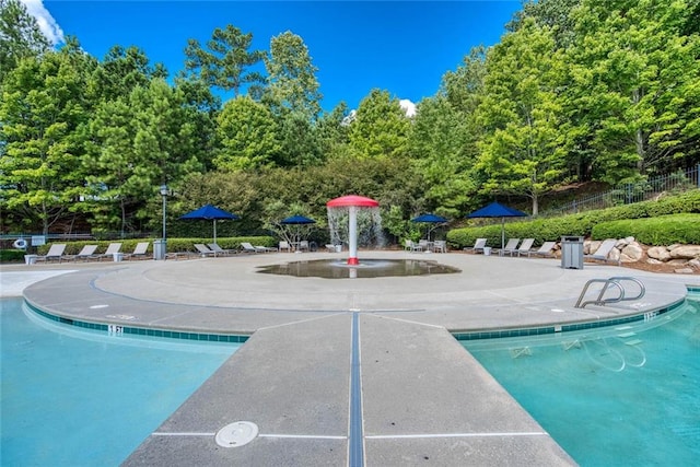 637 Little Bear Loop, Canton, GA 30114 - community pool featuring a patio and view of wooded area