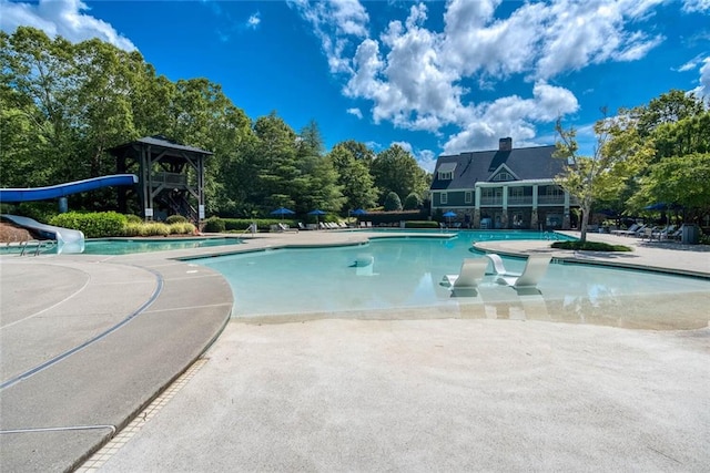 637 Little Bear Loop, Canton, GA 30114 - community pool featuring a water slide, a patio, and view of wooded area