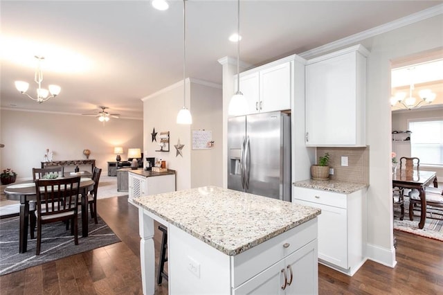 637 Little Bear Loop, Canton, GA 30114 - kitchen with stainless steel fridge with ice dispenser, a chandelier, ornamental molding, dark wood-style floors, and a kitchen island