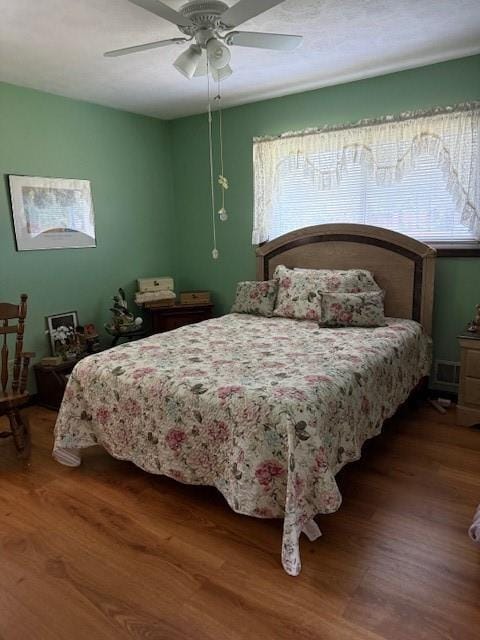 bedroom with wood finished floors and ceiling fan