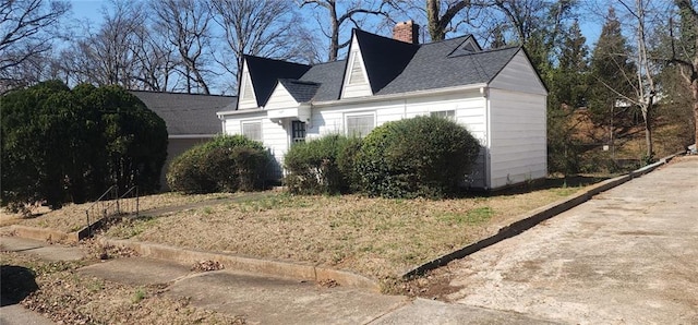 view of property exterior featuring a chimney