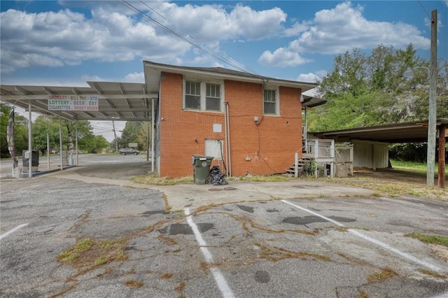 back of property featuring a carport