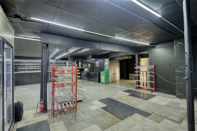 basement featuring light tile flooring and heating utilities