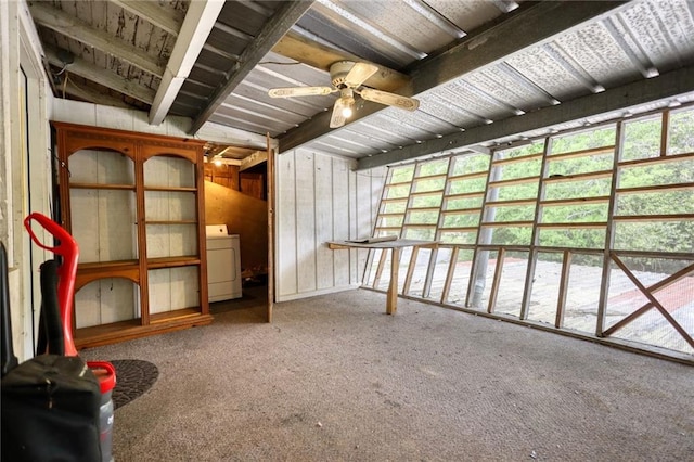 misc room with wood walls, carpet, washer / clothes dryer, and ceiling fan