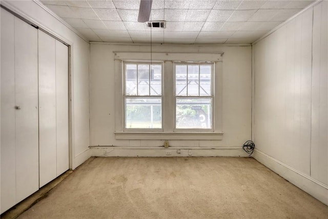 interior space featuring light carpet and multiple windows