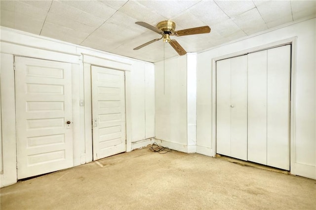 unfurnished bedroom featuring ceiling fan and light carpet