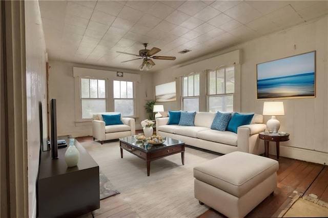 living room with light hardwood / wood-style flooring and ceiling fan