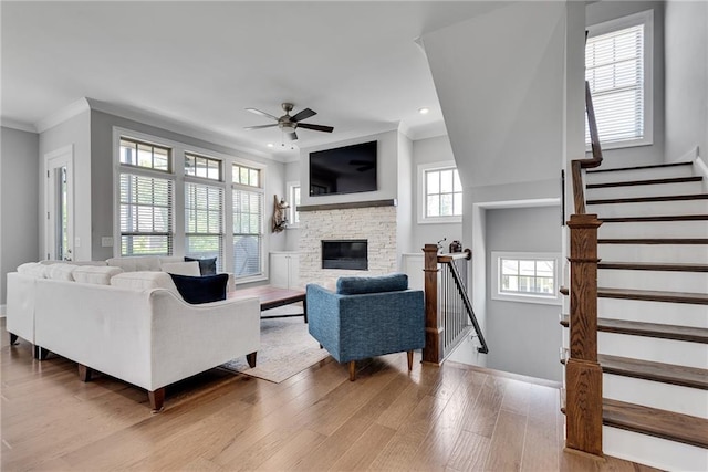 3108 Huntington Pl, Milton, GA 30004 - living area with crown molding, ceiling fan, recessed lighting, light wood-style floors, and a fireplace