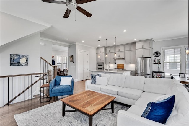 3108 Huntington Pl, Milton, GA 30004 - living room featuring ceiling fan, ornamental molding, healthy amount of natural light, light wood-type flooring, and recessed lighting