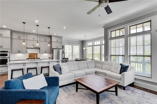 3108 Huntington Pl, Milton, GA 30004 - living area with a ceiling fan, crown molding, light wood finished floors, recessed lighting, and baseboards
