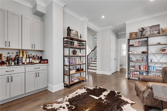 3108 Huntington Pl, Milton, GA 30004 - indoor dry bar with ornamental molding, wood finished floors, baseboards, stairway, and recessed lighting