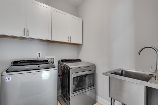 3108 Huntington Pl, Milton, GA 30004 - washroom with washing machine and dryer, cabinet space, and baseboards