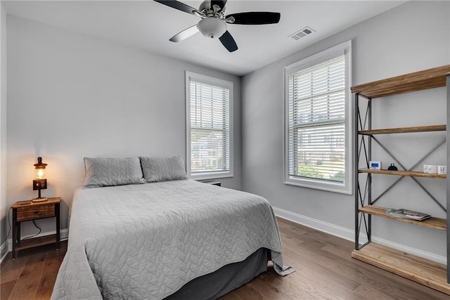 3108 Huntington Pl, Milton, GA 30004 - bedroom with multiple windows, baseboards, wood finished floors, and ceiling fan