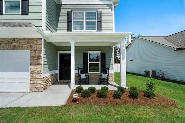22 Mossy Oaks Ln NE, Rome, GA 30165 - view of exterior entry with a porch, stone siding, a lawn, and central AC