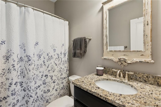 full bathroom with toilet, curtained shower, and vanity