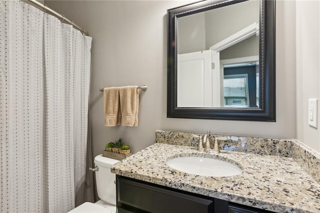 bathroom featuring toilet, curtained shower, and vanity