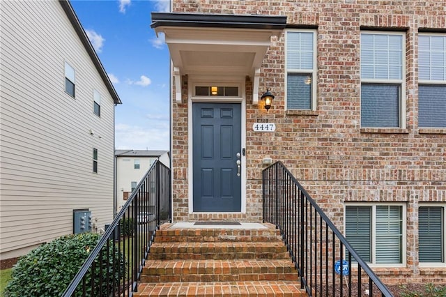 doorway to property with brick siding