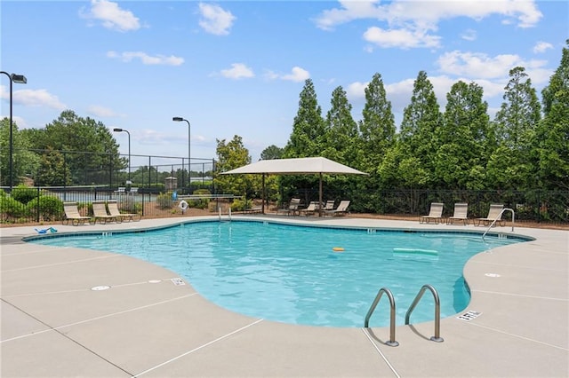 community pool featuring a patio area and fence