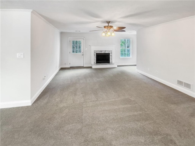 unfurnished living room with visible vents, baseboards, carpet flooring, a fireplace, and a ceiling fan