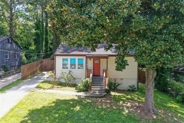 view of front of home featuring driveway, crawl space, a front yard, and fence