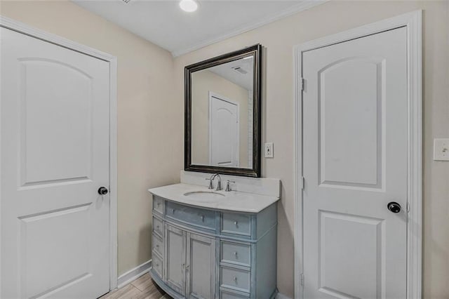 bathroom with vanity, baseboards, and wood finished floors