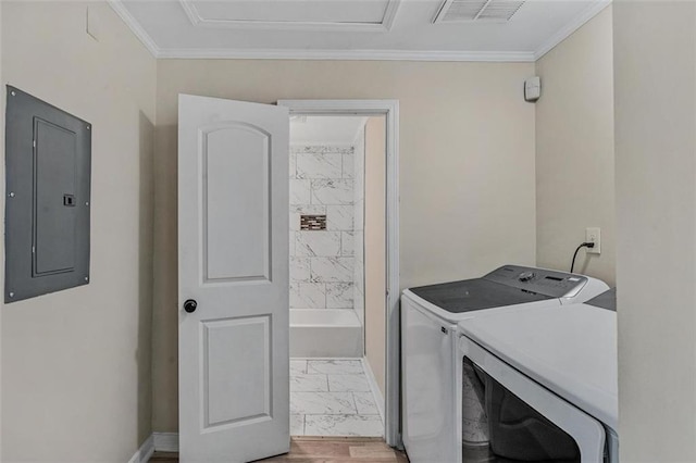 clothes washing area with washing machine and dryer, visible vents, marble finish floor, electric panel, and crown molding