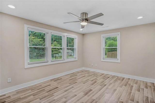 spare room with ceiling fan, recessed lighting, light wood-style flooring, and baseboards