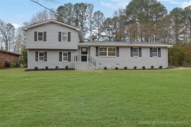 split level home featuring a front yard, brick siding, and crawl space