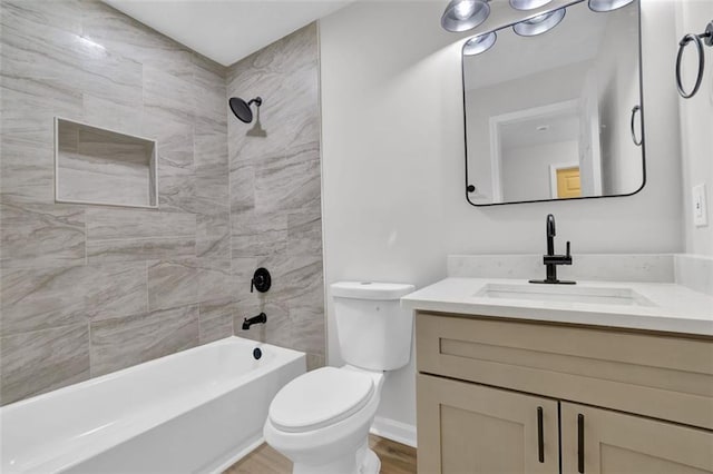 bathroom with vanity, toilet, wood finished floors, and shower / bathtub combination