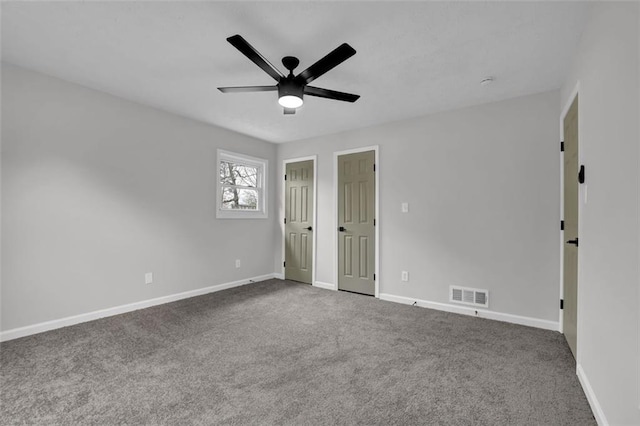 empty room featuring visible vents, baseboards, and carpet