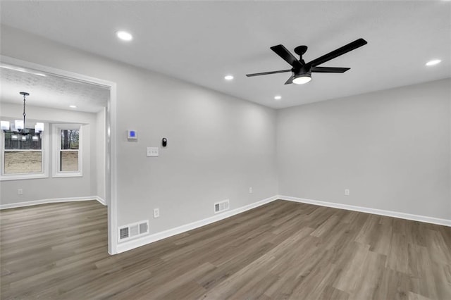 unfurnished room featuring visible vents, recessed lighting, baseboards, and wood finished floors