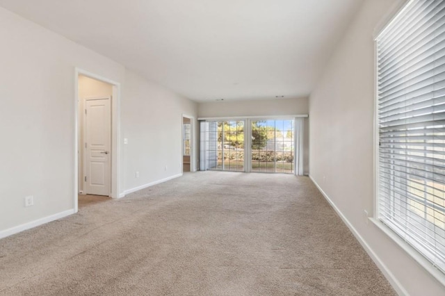 empty room with carpet floors and baseboards