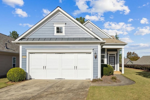view of front of home featuring metal roof, a standing seam roof, and concrete driveway