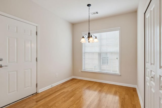interior space with a notable chandelier, visible vents, baseboards, and a healthy amount of sunlight