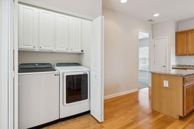 laundry area with light wood-style floors, recessed lighting, washer and dryer, baseboards, and cabinet space